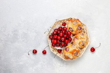 Homemade muffins with sweet red cherries.