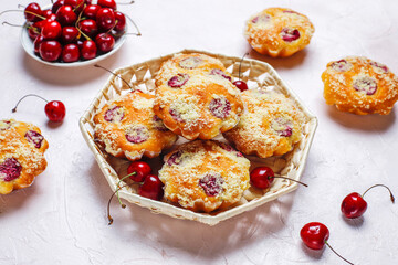 Homemade muffins with sweet red cherries.