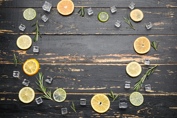 Frame made of healthy citrus fruits and ice cubes on dark wooden background