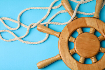 Helm and rope on color background