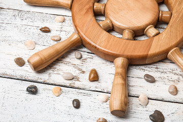 Helm and pebbles on wooden background