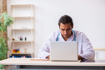 Young male doctor in telemedicine concept