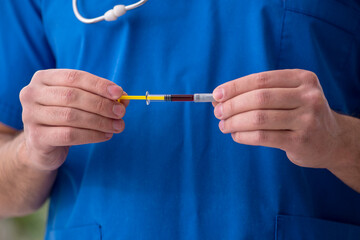 Young male doctor in vaccination concept during pandemic