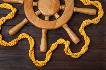 Helm and rope on wooden background