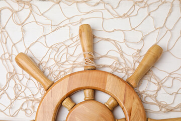 Helm and net on white wooden background