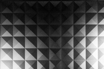 Monochrome image, geometric abstract square pattern on a piece of plastic pc component close up macro shot.