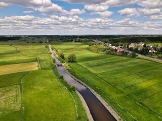 Fields, meadows in rural green areas by the river - top view 