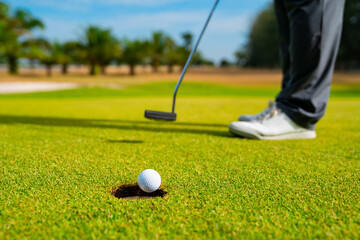 Golfer putting golf ball on the green golf, lens flare on sun set evening time, Pro Golf long...