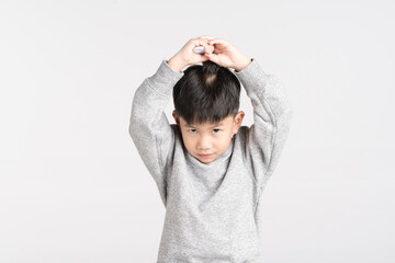 Asian boy holding brush comb for dressing hairstyle