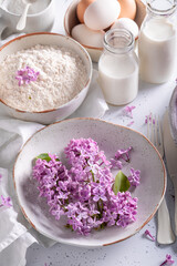 Ingredients for fried lilac flower with powdered sugar. Sweet snack.