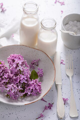 Sweet fried lilac flower in pancake dough. Summer dessert.