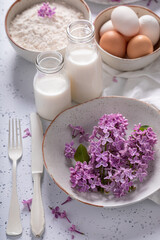 Sweet fried lilac flower with powdered sugar. Summer dessert.