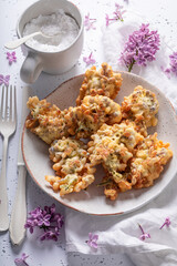 Sweet fried lilac flower with powdered sugar. Sweet dessert.