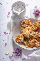 Delicious fried lilac flower in oil. Summer snack.