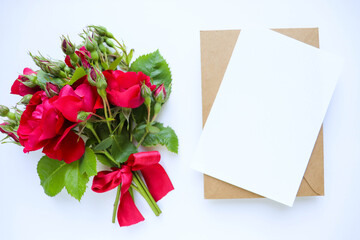 postcard mockup. small bouquet of red roses on a white background and place for text 