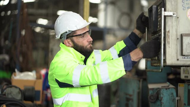 technician Engineer inspecting and controlling and operate heavy machine in the industrial plant  . factory worker maintenance control panels of machinery in production line