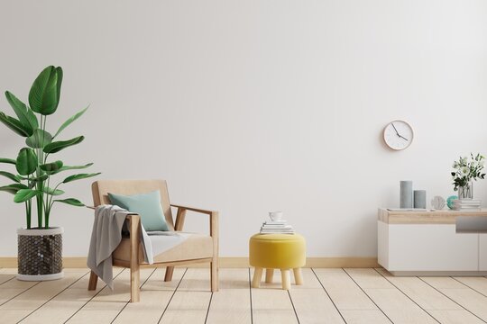 Minimalist interior of living room with design armchair and table on white wall.