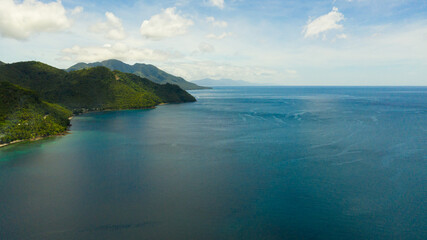 Aerial drone of the coast of Leyte island with hills and mountains covered with green forest and jungle. Philippines.