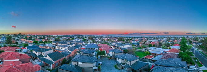 Panoramic aerial Drone view of Melbournes suburbs and CBD looking down at Houses roads and Parks...