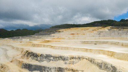 Aerial view of limestone quarry in the mountains among the rainforest. Bohol, Philippines.