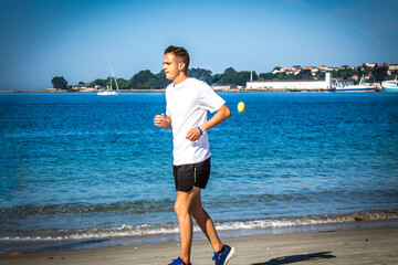 man running on the beach sand