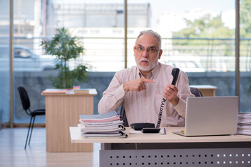 Old male bookkeeper in budget planning concept