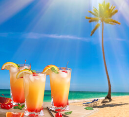 Glasses of tasty tequila sunrise cocktail on table at tropical resort