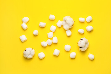 Soft cotton wool balls on color background