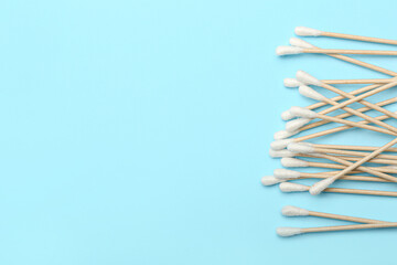 Cotton swabs on color background