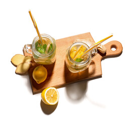 Mason jars of cold ginger lemonade on white background
