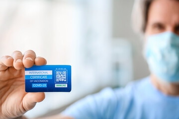 Senior man with International Certificate of Vaccination in clinic