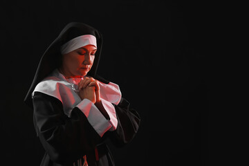 Mature nun on dark background