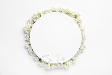 Blank card and beautiful lilac flowers on white background