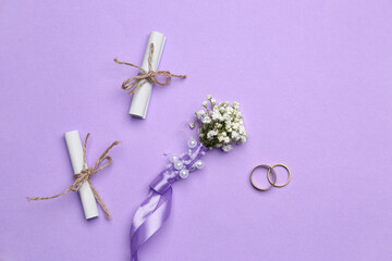 Beautiful gypsophila boutonniere, wedding rings and invitations on color background