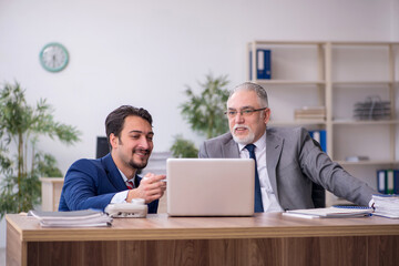 Two male employees working in the office
