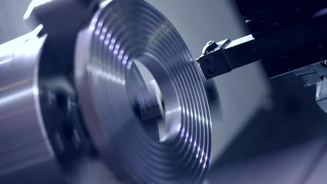 Closeup robot CNC turning milling factory metal machine industry, toning color.