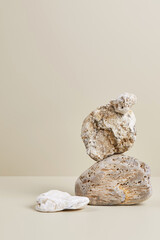 Abstract nature scene with composition of beige and white stones. Neutral background for cosmetic or beauty product branding and packaging mockups. Natural pastel colors. Copy space, front view.