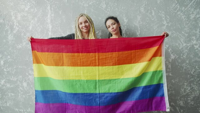 Female lesbian couple with LGBTQIA pride flag