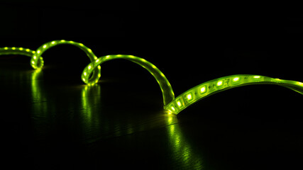 luminous LED decorative strip of green color on a black background