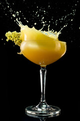 Alcohol cocktail Daiquiri with mango. Mango margarita frappe with splash on black background. Copy...