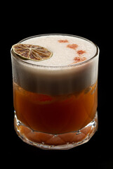 Whiskey stout sour with orange slice on black background