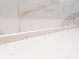 Countertop marble skirting board, wall border. White marble countertop, kitchen countertop with...