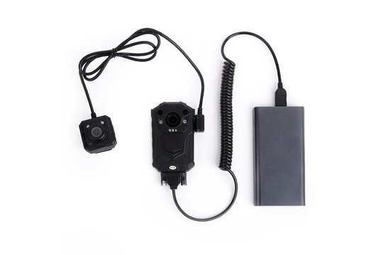 Black Body Camera, Mini Camera, Spiral Cable And Power Bank. Officer Body Cam. Personal Wearable Video Recorder, Portable DVR, Camera Isolated On White Background. Closeup, Front View