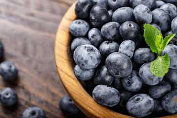 Freshly picked blueberries in a wooden bowl. Healthy berry, organic food, antioxidant, vitamin