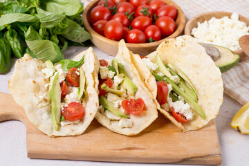 vegan taco with vegetable, kidney beans and salsa. ingredients for vegan tacos