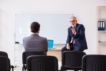 Two businessmen in the classroom in pandemic concept