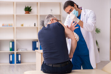 Old man visiting young doctor in covid-19 vaccination concept