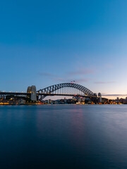 Dawn view of Sydney Harbour Bridge with clear sky.