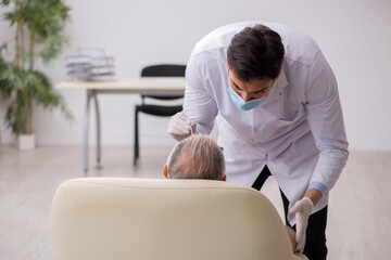 Old male patient visiting young male doctor otorhinolaryngologis