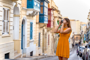 Fototapeta na wymiar Portrait of a beautiful woman in a traditional Sliema alley. Malta